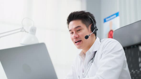 Asian male medical doctor talking virtual online with patient at home.