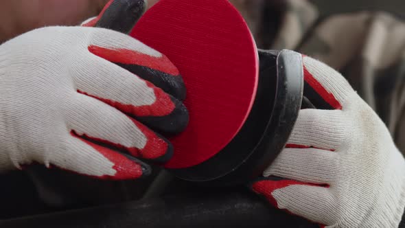 Human Hands in Neon Gloves Install Support Plate with Velcro on the Angle Grinder Closeup