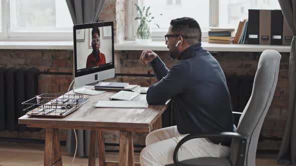 Middle Eastern Man Speaking with African American Woman on Video Call