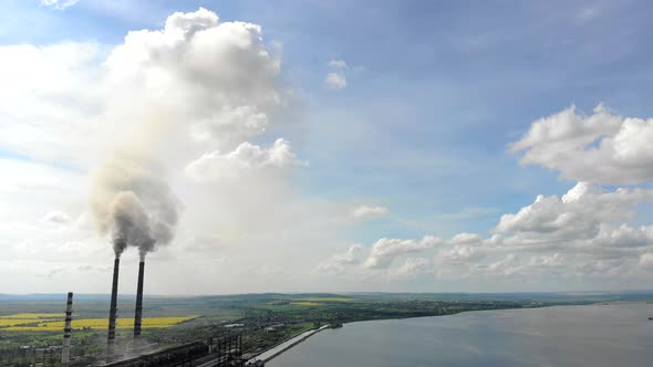 Aerial View Environmental Pollution. Two Tall Pipes That Emit Black Smoke Into the Atmosphere