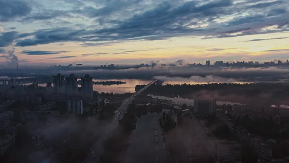 Panoramic Aerial View of Rainy City After Sunset Cloudy Sky Smog Residential Area Cars Passing Along