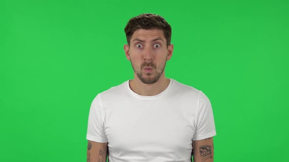 Portrait of Confident Guy with Shocked Surprised Wow Face Expression. Green Screen