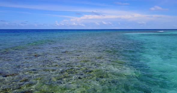 Wide drone copy space shot of a white paradise beach and blue sea background in hi res 4K