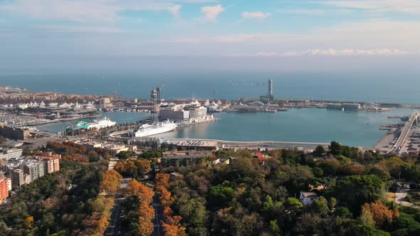 Aerial drone view of Barcelona city sea coastline with port. Sunny day. Montjuic district. Spain