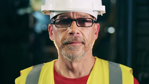 Face of a Bearded Engineer Wearing Glasses and a Hardhat