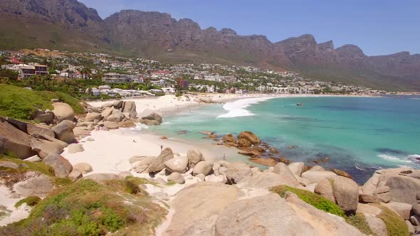 Aerial travel drone view of Camps Bay beach, Cape Town, South Africa.