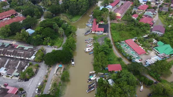 Aerial view fishing boat at river near the residential house