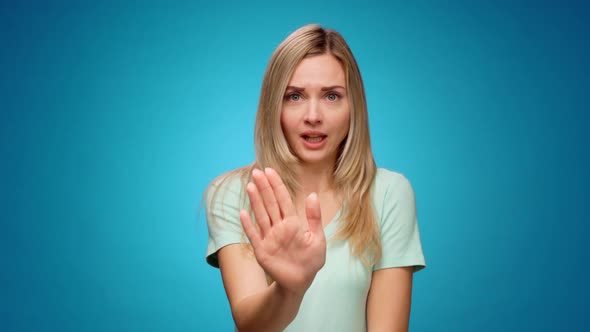 Displeased Young Woman Covering Eyes and Gesturing Stop Against Blue Background