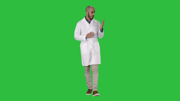 Middle age doctor man wearing medical uniform presenting