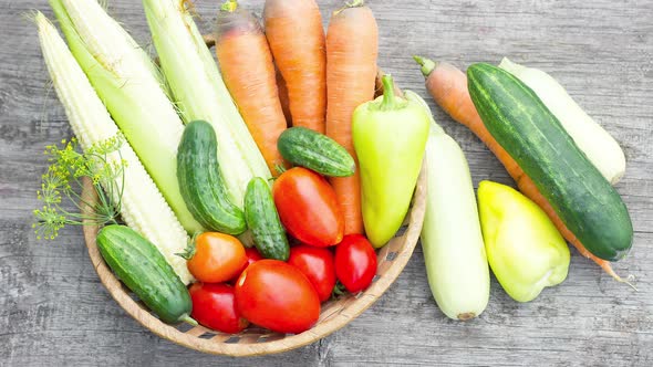 Wicker Basket with Ripe Homemade Vegetables on Wooden Old Background