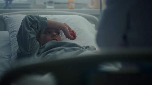 Little Patient Lying in Clinic Bed