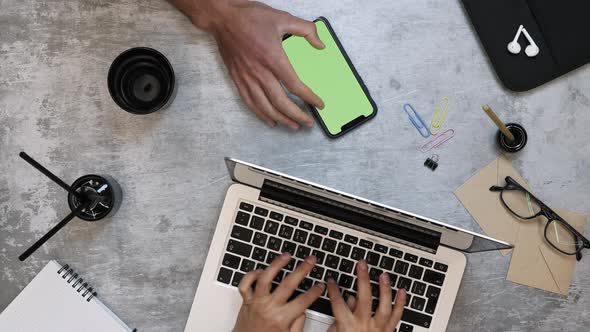 Business people working on laptop computer and smartphone with chroma key green screen