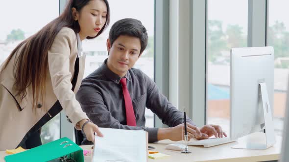 Two Business People Talk Project Strategy at Office