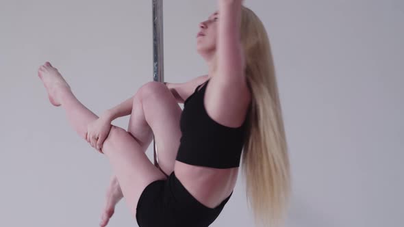 Pole Dancing  Blonde Woman Slowly Spinning on the Pole