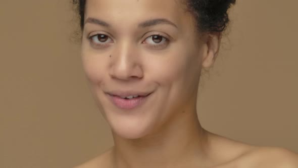 Beauty Portrait of Young African American Woman Pointing Up Hand for Something Then Nods and Shows