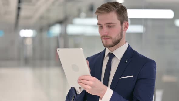 Young Businessman Using Digital Tablet