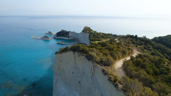 Drone Over Coastline Cliffs And Sea At Sunrise Of Cape Drastis