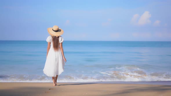 Asian woman enjoy around beautiful beach sea ocean