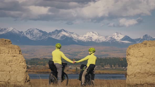 The Man and Woman Travel on Mixed Terrain Cycle Touring with Bikepacking