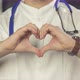 Close up of doctor with stethoscope showing heart gesture with his hands - VideoHive Item for Sale
