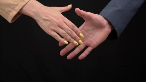 Two Businessmen Shake Hands on a Black Background Good Deal