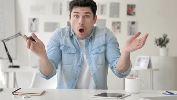 Casual Young Man in Shock at Workplace