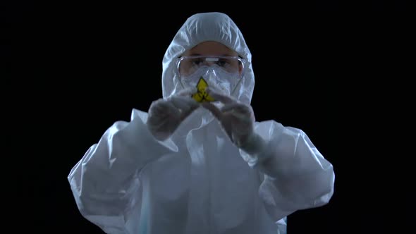 Laboratory Worker in Protective Suit Showing Biological Hazard Symbol, Weapon