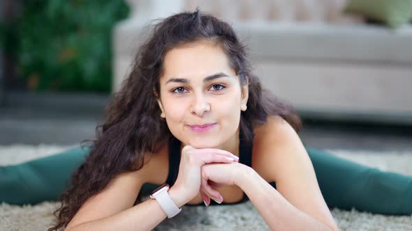 Medium Closeup Happy Friendly Brunette Fit Woman with Curly Hair Smiling and Looking at Camera