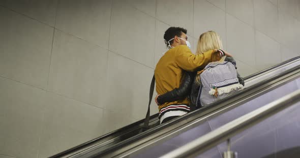 Caucasian couple on the go wearing a coronavirus covid19 mask