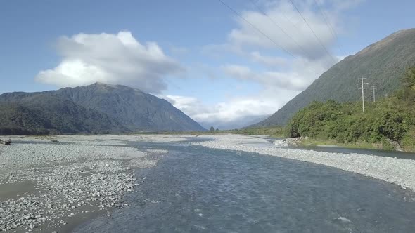 Shallow water of river in terrain with mountains