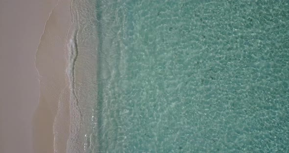 Natural overhead abstract view of a sunshine white sandy paradise beach and aqua blue ocean