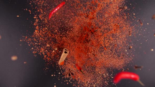 Exotic Spices and Chilli Pepper Flying Up and Falling Down in Slow Motion