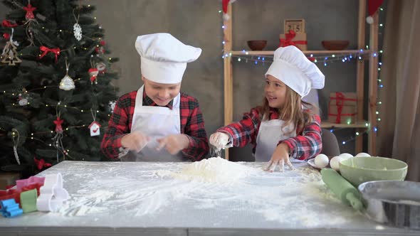 Pretty Kids in Chef Uniforms Make Christmas Cookies and Dabble in Flour at the Table