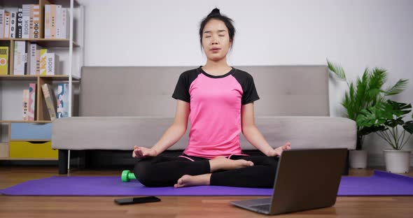 Woman meditating in lotus position sitting