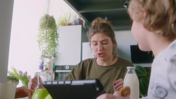 Little Boy Chatting with Lesbian Parents on Breakfast