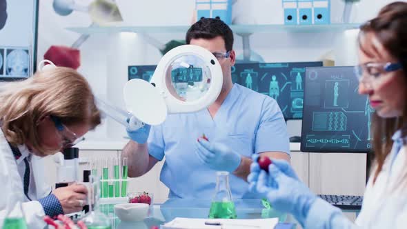 Male Assistant Looking at Food Samples Using a Magnifying Glass