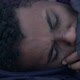 Close-up of bruised black teen boy lying on street and coughing - VideoHive Item for Sale