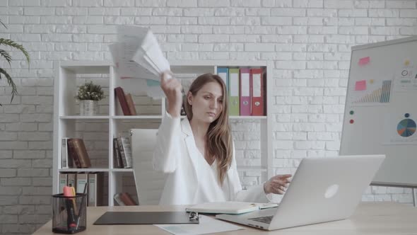 Tired and Nervous Office Woman Worker Throws the Paper at Workplace