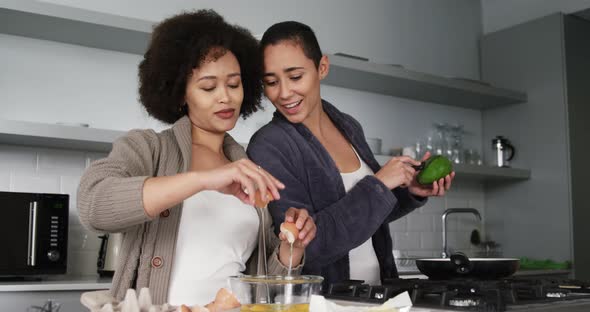 Lesbian couple preparing breakfast in kitchen