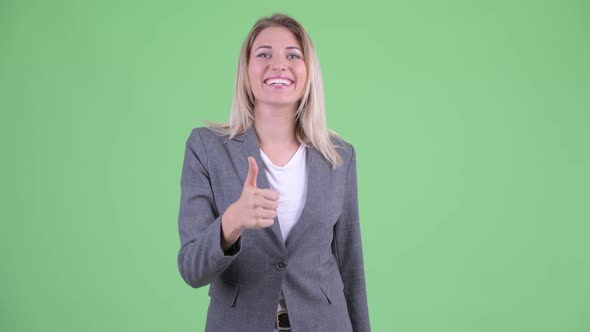 Happy Young Beautiful Blonde Businesswoman Giving Thumbs Up