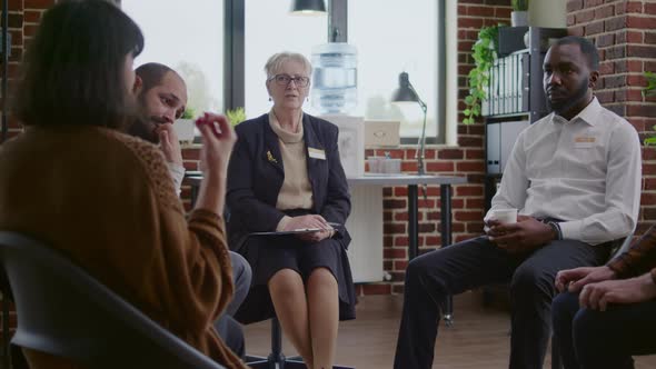 Woman Therapist Listening to People with Addiciton Problems at Aa Group Meeting