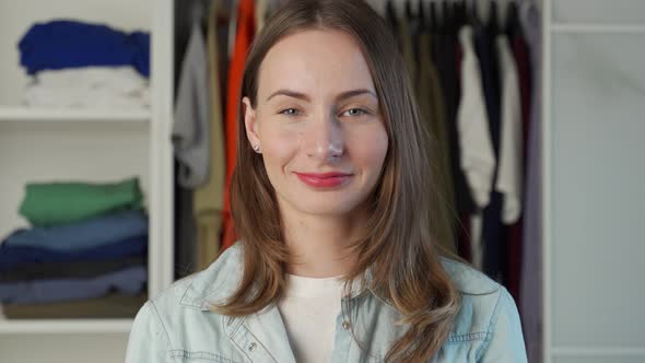 Portrait of a Woman Who Stands Against the Background of a Large Wardrobe a Wardrobe with Stylish