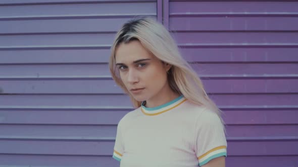 Woman grunge standing at a colorful wall