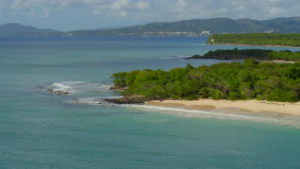 Aerial of beautiful sea and green forest on coast