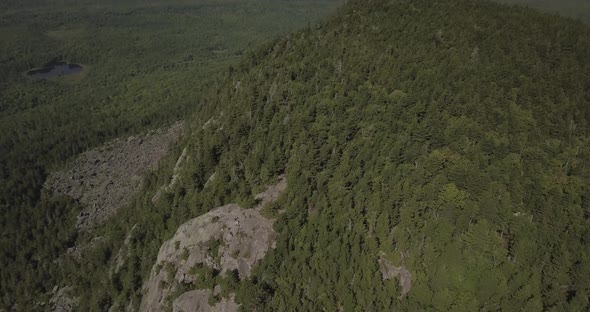 Aerial Drone Shot Flying Over Tree Covered Mountain