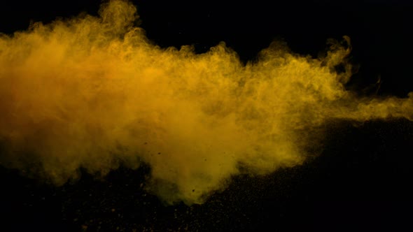 Super Slowmotion Shot of Yellow Powder Explosion Isolated on Black Background