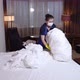 Masked Housemaid Removing Durty Linens From Bed - VideoHive Item for Sale