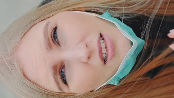 Crane Shot of Blonde Woman Looking Into the Sky and Putting on Medical Mask