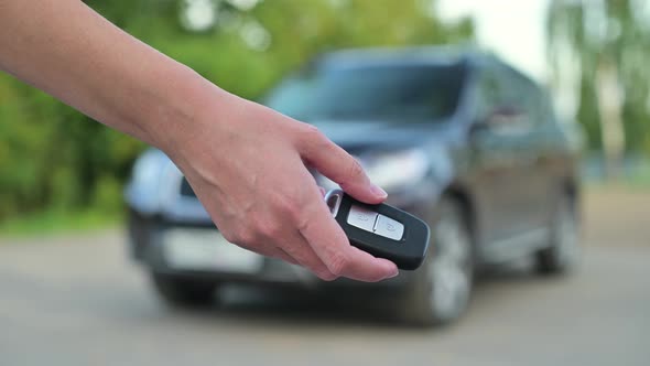 Car sale. A woman gives a man a key and takes money in return, selling him car