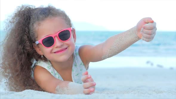 Close-Up Portrait of a Beautiful Little Girl in Pink Glasses, Cute Smiling Looking at the Camera